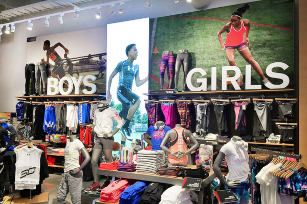 image displays a retail store section dedicated to athletic apparel for children