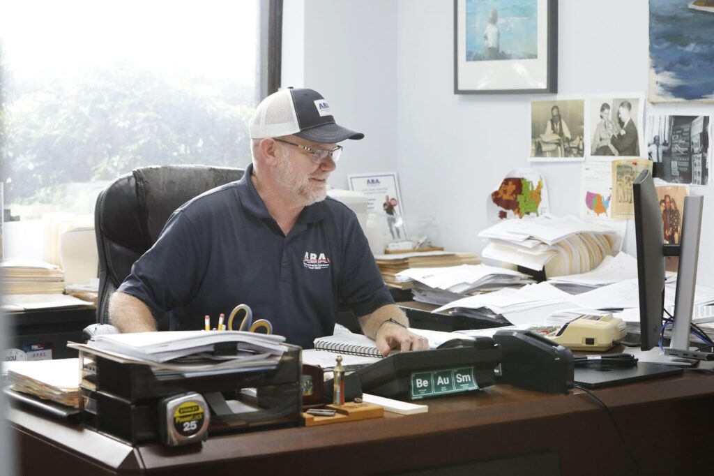 Albert Basse Associates team member working at his desk, reflecting the company's expertise in print and digital printing services.